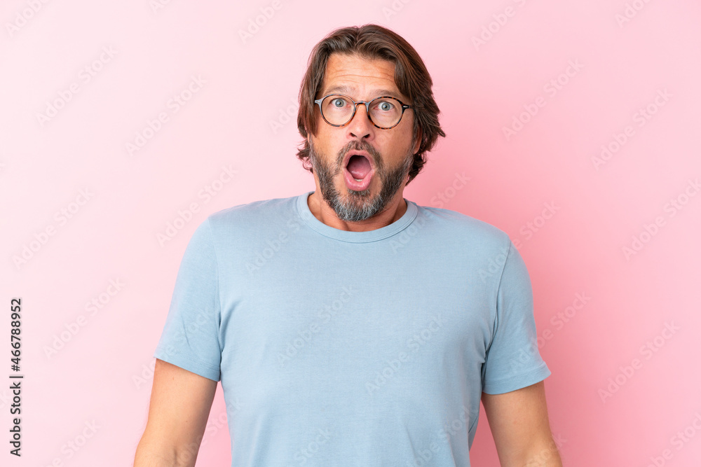 Senior dutch man isolated on pink background With glasses and surprised expression Senior dutch man isolated on pink background With glasses and surprised expression
