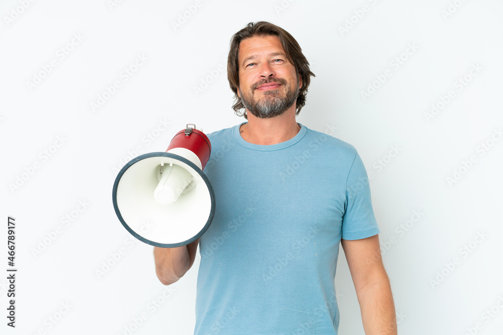 Senior dutch man isolated on white background holding a megaphone and smiling a lot Senior dutch man isolated on white background holding a megaphone and smiling a lot