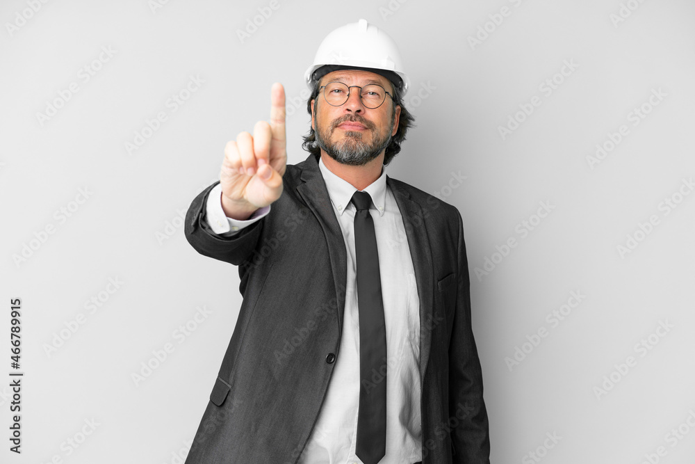 Young architect man with helmet over isolated background showing and lifting a finger Young architect man with helmet over isolated background showing and lifting a finger