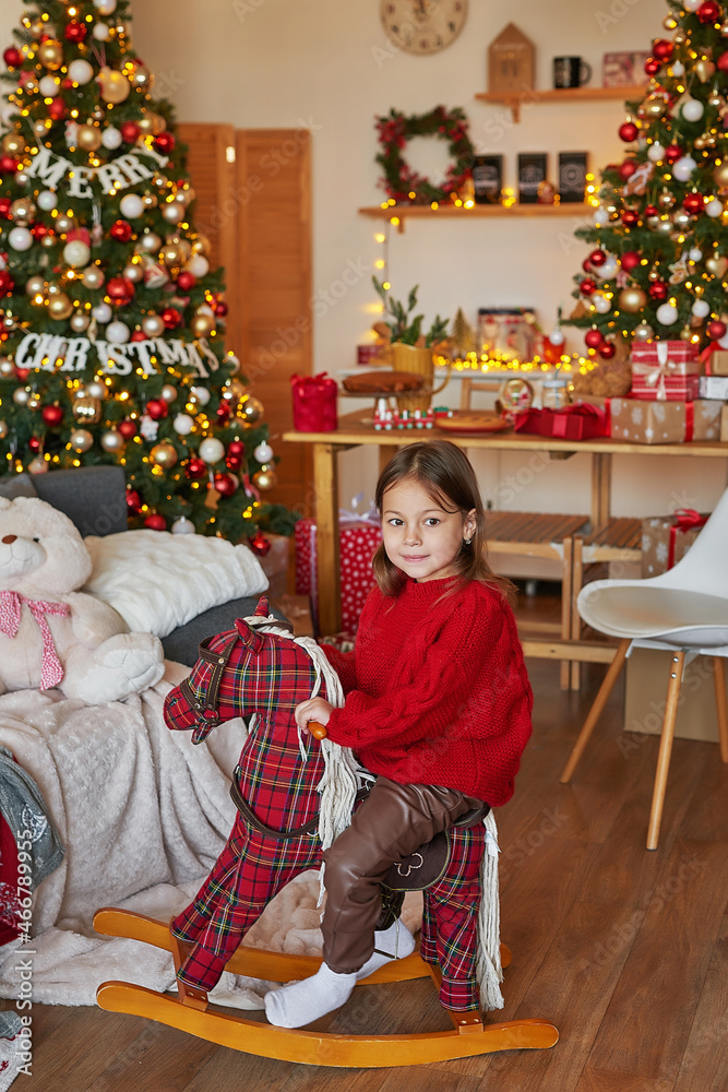 Christmas family. Child girl on background of Christmas tree. New Year celebration. Merry Christmas and Happy New Year.