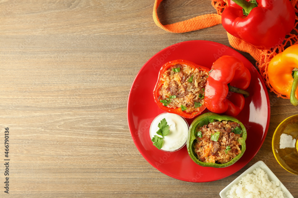 Concept of tasty food with stuffed pepper on wooden background Concept of tasty food with stuffed pepper on wooden background