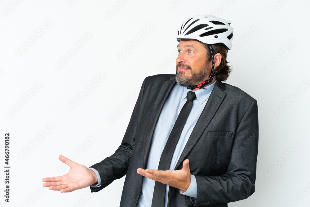 Business senior man with a bike helmet isolated on white background with surprise facial expression Business senior man with a bike helmet isolated on white background with surprise facial expression