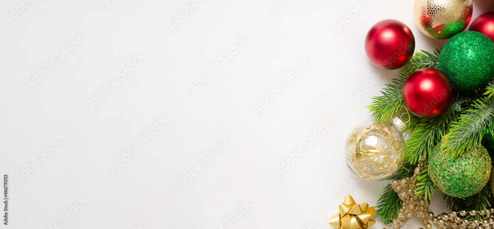 Christmas background with fir branches, red and gold decorations on a white background. Flat lay. top view with copy space. banner