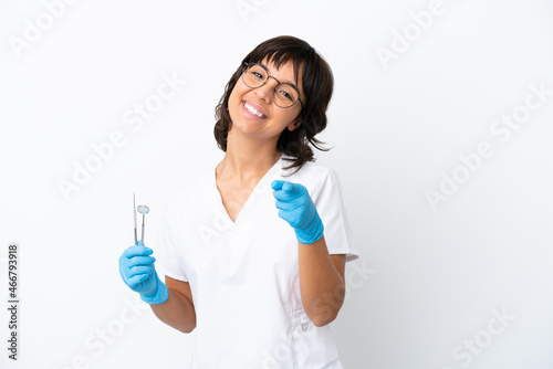 Young woman holding tools isolated on white background pointing front with happy expression