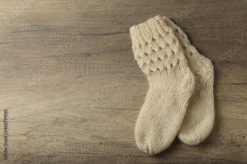 Pair of woolen socks on wooden background photo