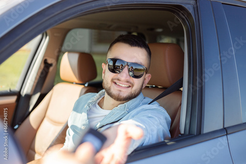 Businessman getting his new car key in his car.