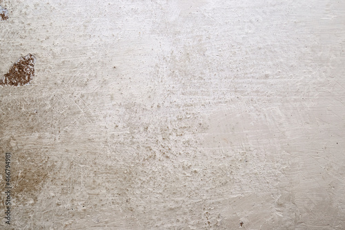 Texture of the whitewashed wall with scuffs, scratches and dirty spots