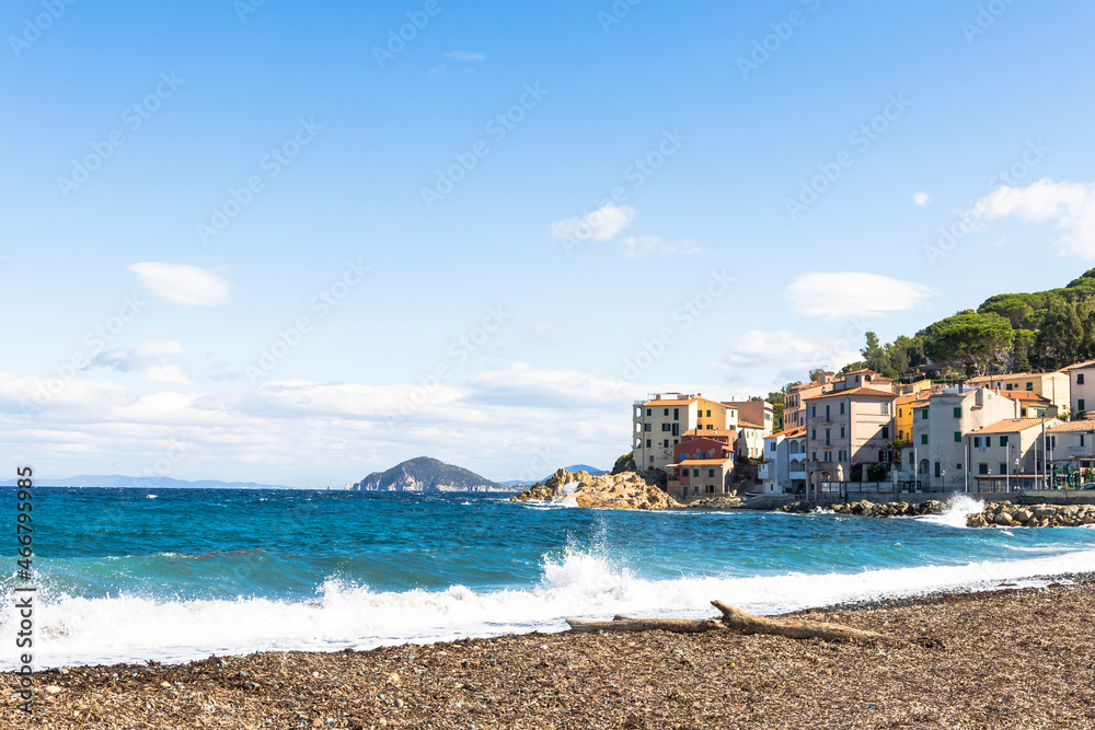 View over the beach and houses and hills of Marciana Marina on the coast of the island of Elba