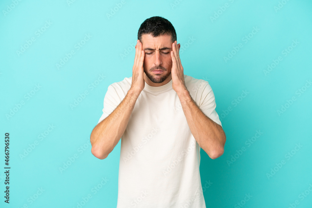 Young handsome caucasian man isolated on blue background with headache Young handsome caucasian man isolated on blue background with headache