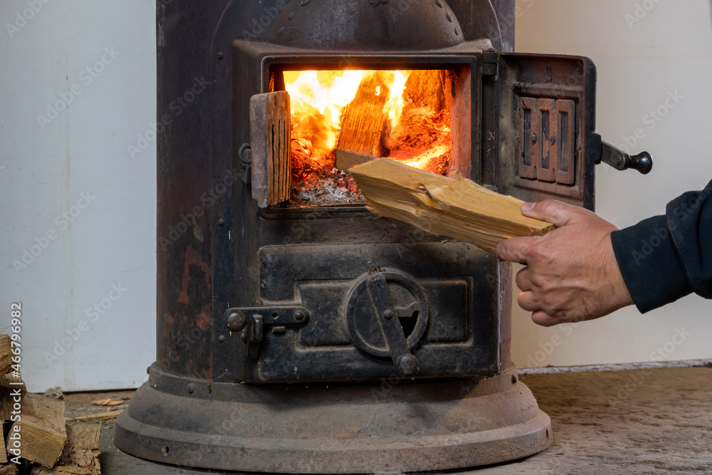 Fire in an old stove. Furnace of the stove in the house. Lighting a fire in