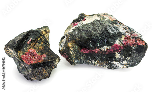 Two pieces of rock interspersed with the mineral eudialyte on a white background photo