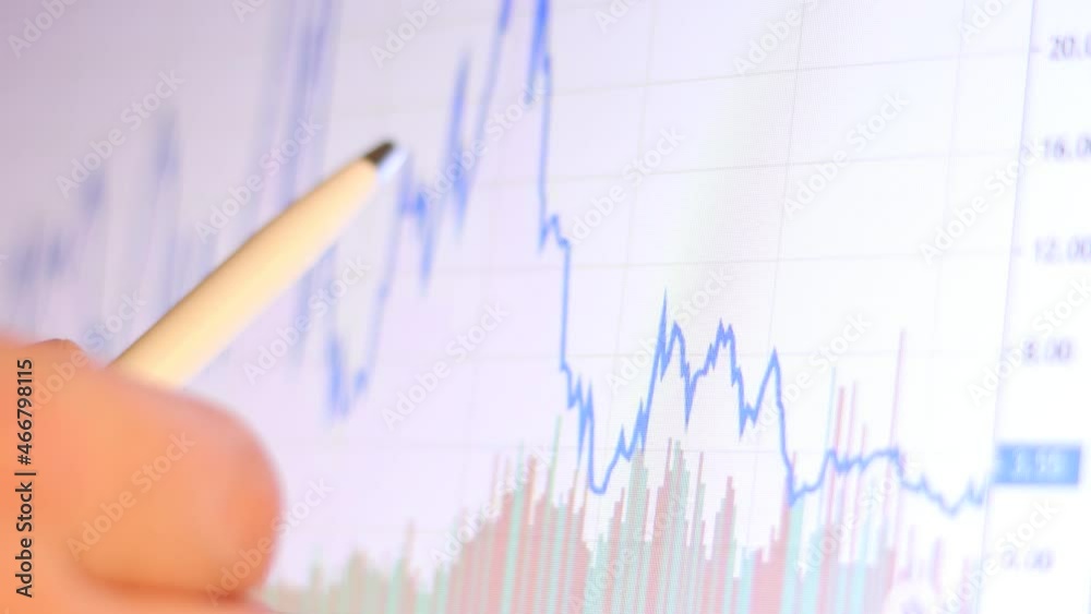 Businessman shows a stock exchange graph and analyzes the stock market.