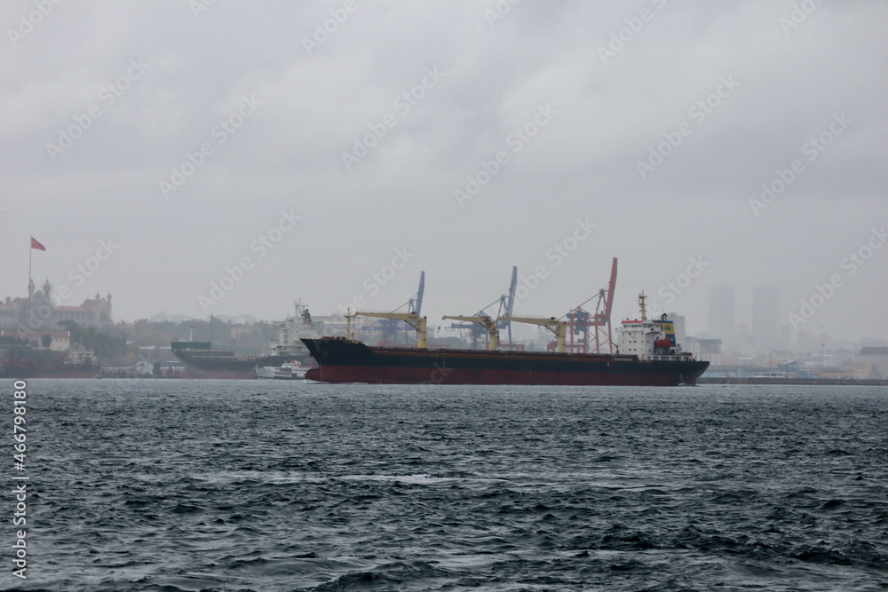 cargo ship in the Bosporus strait with Istanbul city view on background