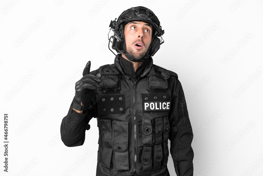 SWAT caucasian man isolated on white background thinking an idea pointing the finger up