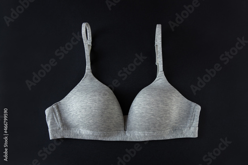 Wallpaper Mural Gray organic or recycled cotton bra on black background, top view, copy space, flat lay. Concept of femininity, comfort, home clothes, underwear, natural textile, minimal style. Horizontal Torontodigital.ca