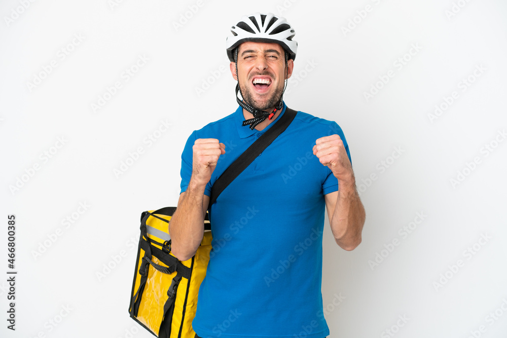 Young caucasian man with thermal backpack isolated on white background celebrating a victory in winner position Young caucasian man with thermal backpack isolated on white background celebrating a victory in winner position