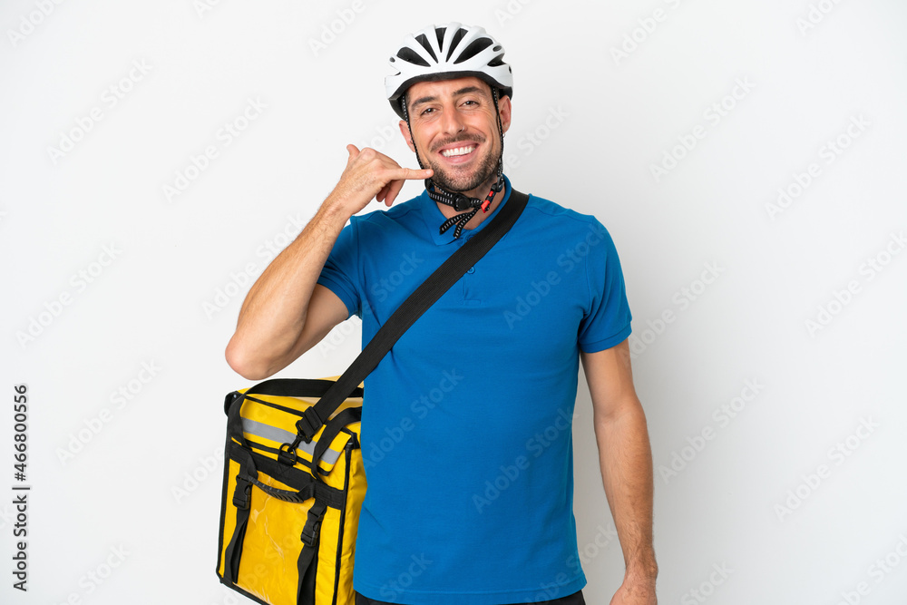 Young caucasian man with thermal backpack isolated on white background making phone gesture. Call me back sign Young caucasian man with thermal backpack isolated on white background making phone gesture. Call me back sign