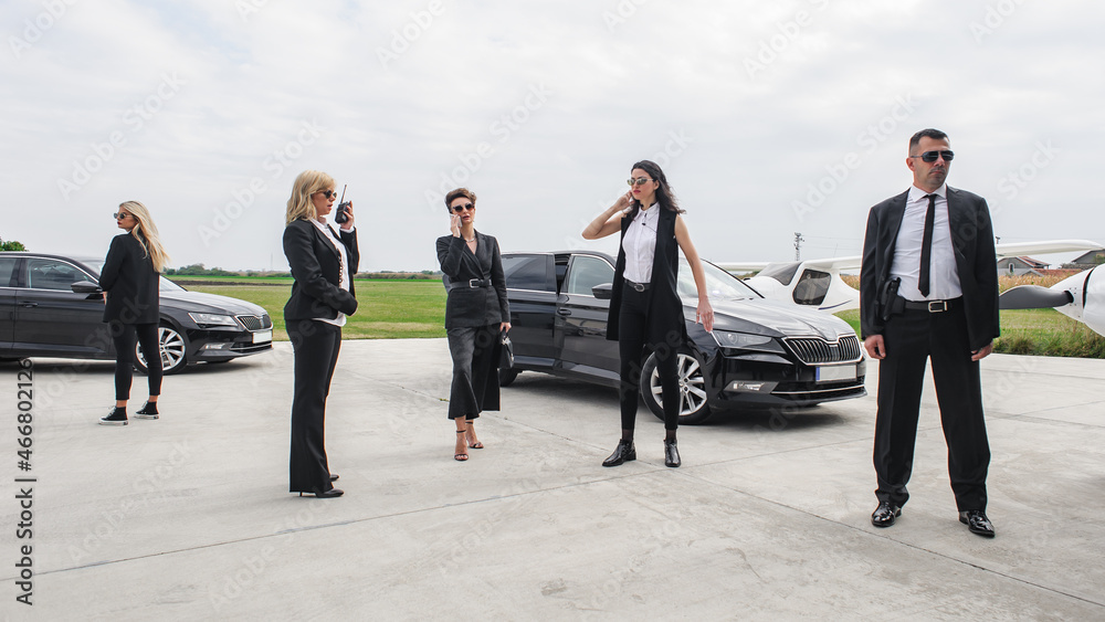 Female male security bodyguards team protect VIP celebrity public person Female male security bodyguards team protect VIP celebrity public person