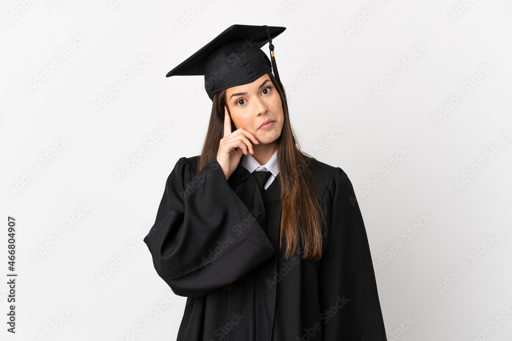 Teenager Brazilian university graduate over isolated white background thinking an idea Teenager Brazilian university graduate over isolated white background thinking an idea
