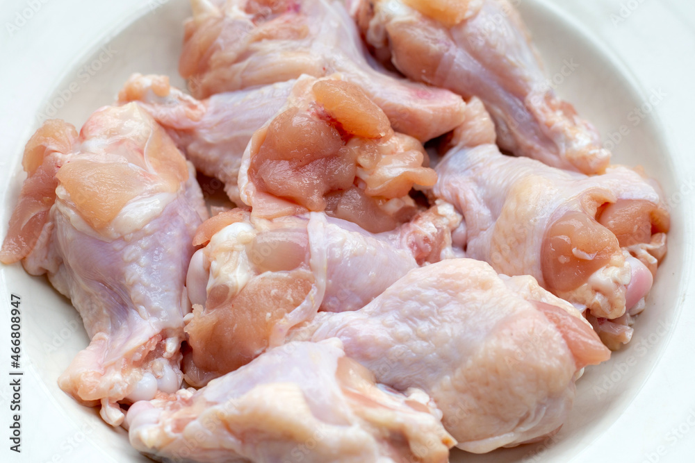 Fresh raw chicken wings (wingstick) in white bowl Fresh raw chicken wings (wingstick) in white bowl