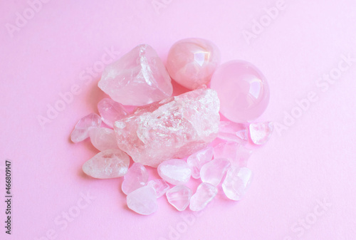 Crystals of rose quartz on a pink background. Beautiful semi-precious stones