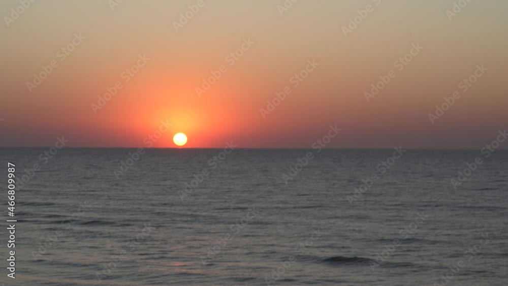 Sunrise or sunset sea.Grass swaying in wind against background sunrise,sunset and sea waves.Bright orange sun reflected in sea,ocean.Beautiful natural video.Early morning,sea travel,relaxation by sea Sunrise or sunset sea.Grass swaying in wind against background sunrise,sunset and sea waves.Bright orange sun reflected in sea,ocean.Beautiful natural video.Early morning,sea travel,relaxation by sea