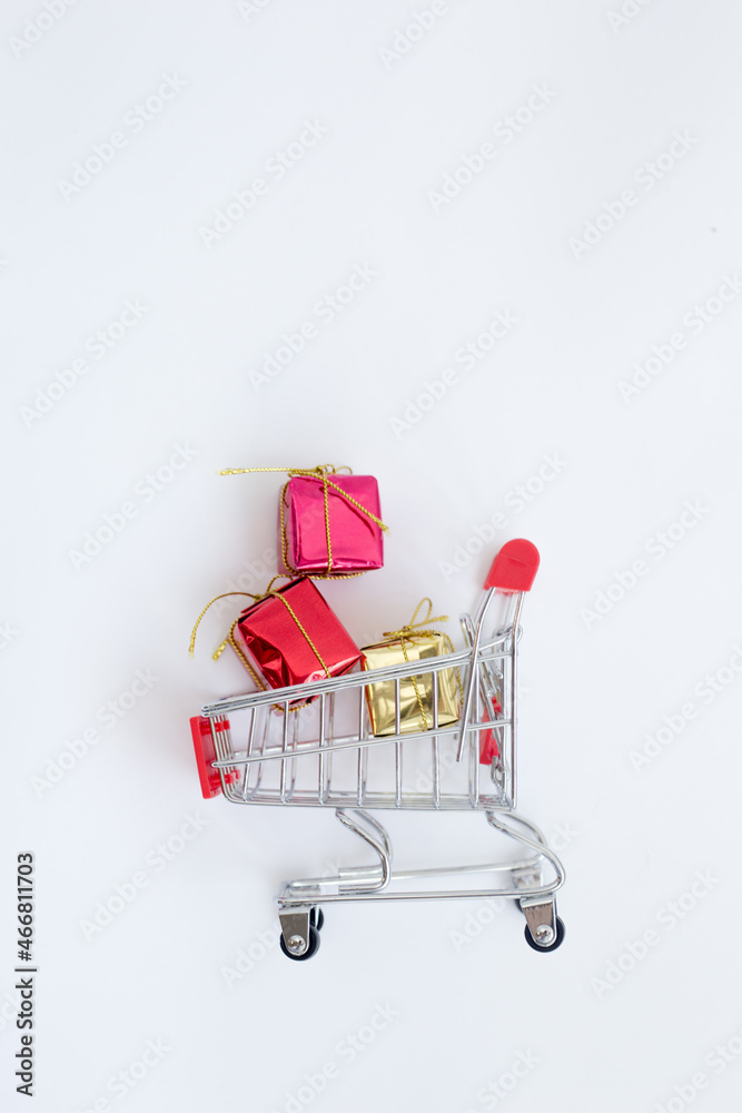 small shopping cart with christmas gifts. Annual sale shopping season concept