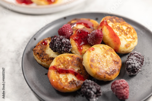 Plate of delicious cottage cheese pancakes with raspberry and blackberry, closeup