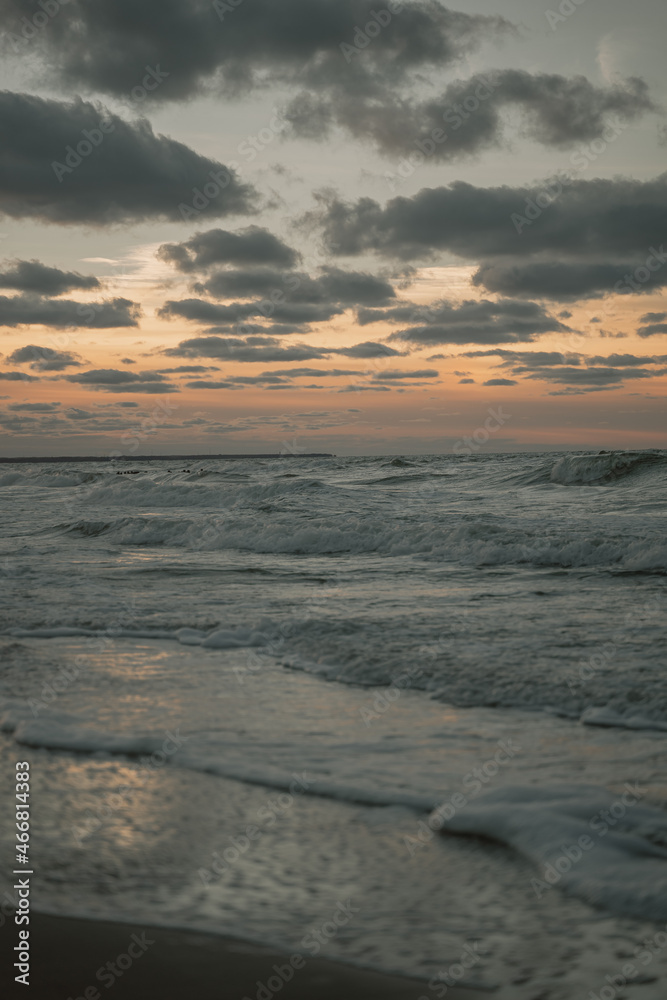 seascape during sunset, clouds float smoothly across the sky, curtain sea big waves