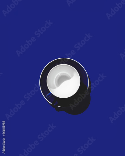 Blue empty cup on a blue background. Copy space.