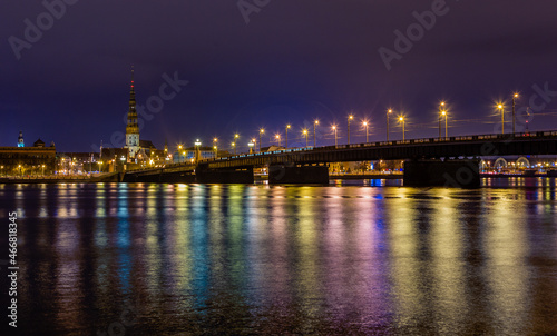 Night view to the historical city center and Stone bridge from the banks of Daugava river colored with street lights, Riga, Latvia © vadim.nefedov