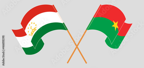 Crossed flags of Tajikistan and Burkina Faso. Official colors. Correct proportion