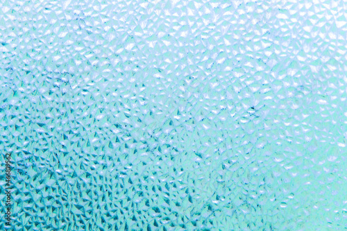refreshing background: imitation of dew on a transparent surface, color toning, short focus.