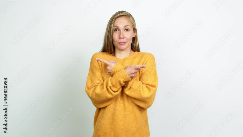 Young blonde girl pointing to the laterals having doubts over isolated background Young blonde girl pointing to the laterals having doubts over isolated background