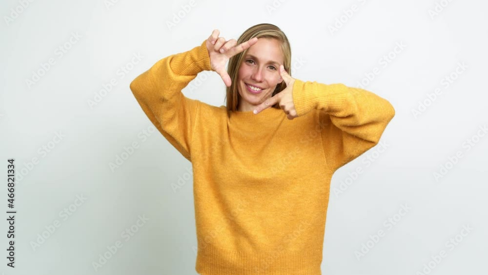 Young blonde girl focusing with fingers over isolated background Young blonde girl focusing with fingers over isolated background