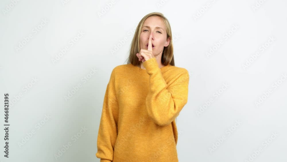Young blonde girl doing silence gesture over isolated background Young blonde girl doing silence gesture over isolated background