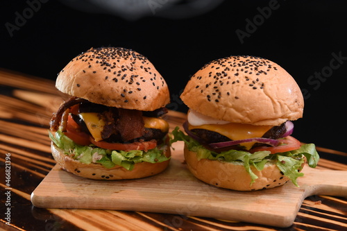 Dois Hambúrgueres artesanais em fundo preto photo
