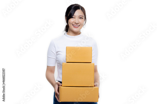 Happy Asian woman holding package parcel boxs isolated on white screen background with copy space, Delivery courier and shipping service concept. © RedcupStudio