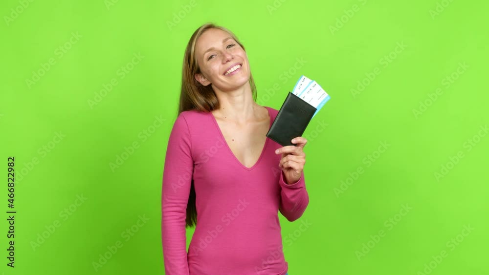 Young blonde girl holding a boarding pass over isolated background. Green screen chroma key Young blonde girl holding a boarding pass over isolated background. Green screen chroma key