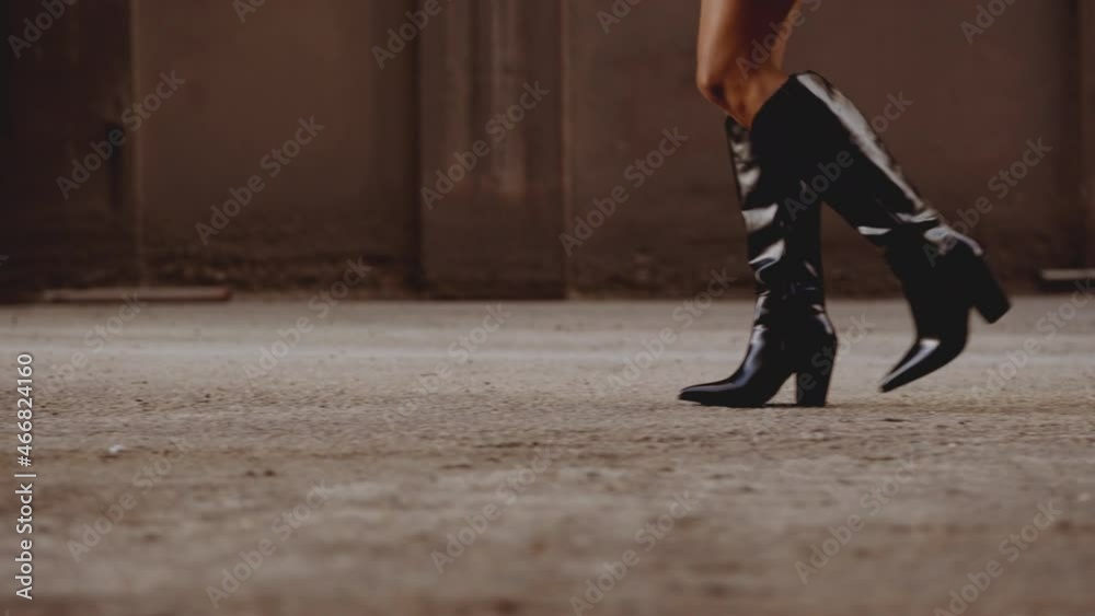 Smiling Young Woman In Boots Walking Along Street Smiling Young Woman In Boots Walking Along Street