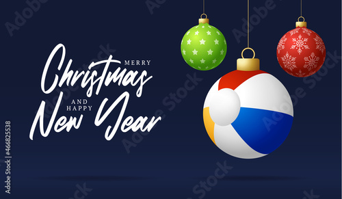 beach ball Christmas card. Merry Christmas holiday relax sunny greeting card. Hang on a thread beach ball as a xmas ball and golden bauble on black background. Sport Vector illustration.
