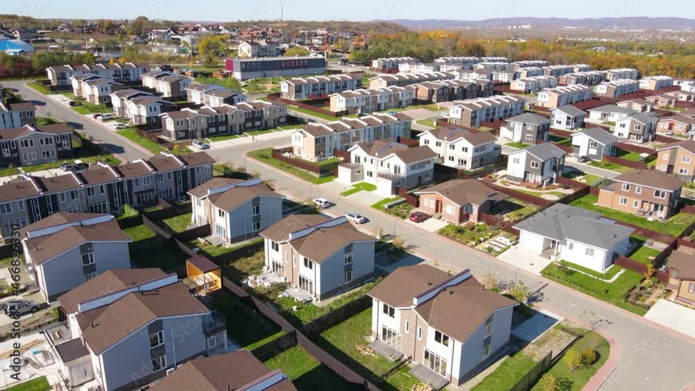 The camera flies over residential townhouses in a gated community. Cottage village in the suburbs of Vladivostok. View from above. The camera flies over residential townhouses in a gated community. Cottage village in the suburbs of Vladivostok. View from above.