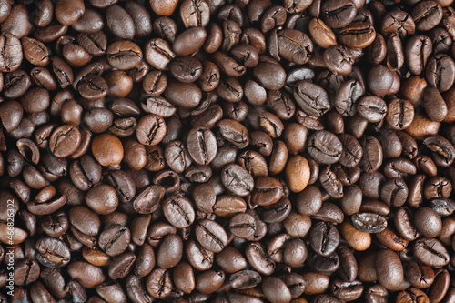 Dark roasted Robusta coffee beans with close up shot,top view.