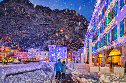 Beautiful night in Riva del Garda on a winter day with lots of snow, View of the beautiful Lake Garda in a snowy day surrounded by mountains, Trentino Alto Adige region