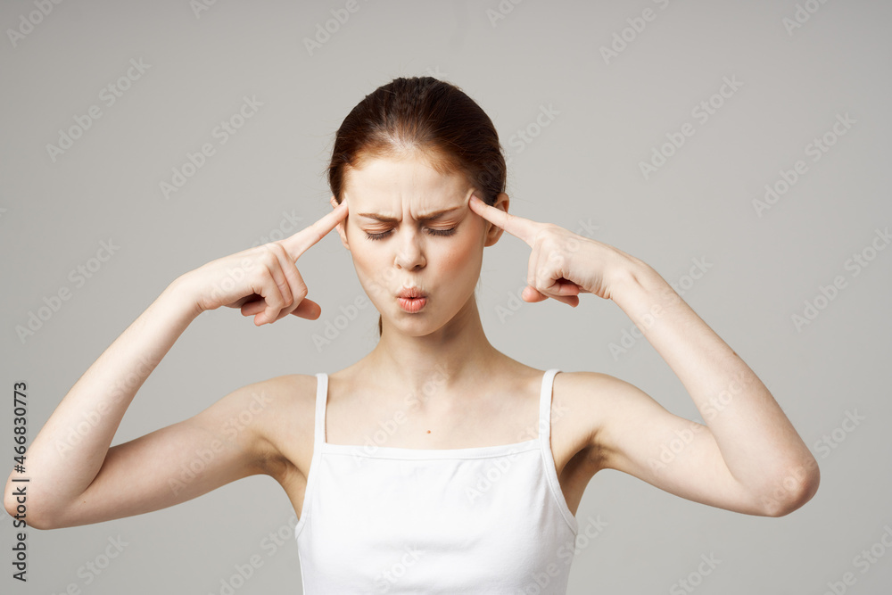 woman in white t-shirt depression symptoms headache light background woman in white t-shirt depression symptoms headache light background