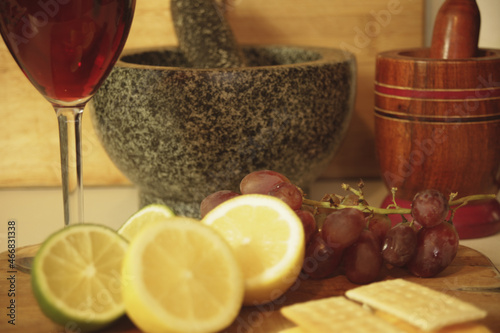 Fresh grapes with a twist of lemon and lime mix with cheese and cracker with a glass of red wine