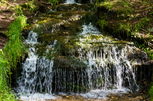 Small waterfall on a forest stream, a picturesque natural monument