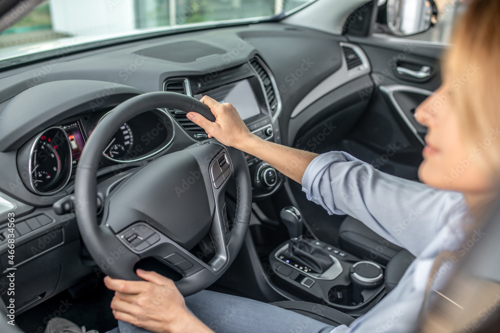 Confident woman driving in car during day