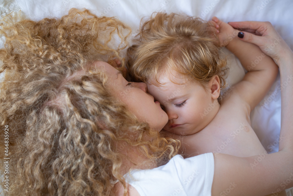 Young mother and baby child sleeping together. Dreams and kids sleep. Young mother and baby child sleeping together. Dreams and kids sleep.