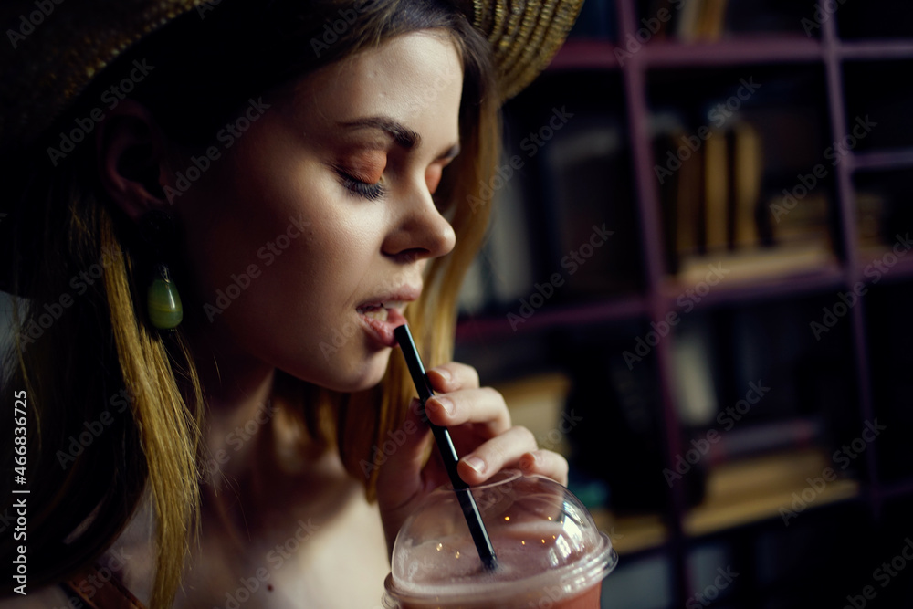 Fototapeta premium pretty woman sitting at a table with a drink in a cafe communication